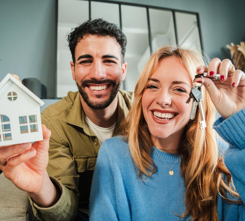 a couple holding keys to a new home