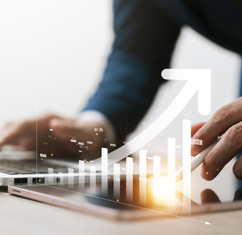 a tablet with a growth graph overlaid on top of it